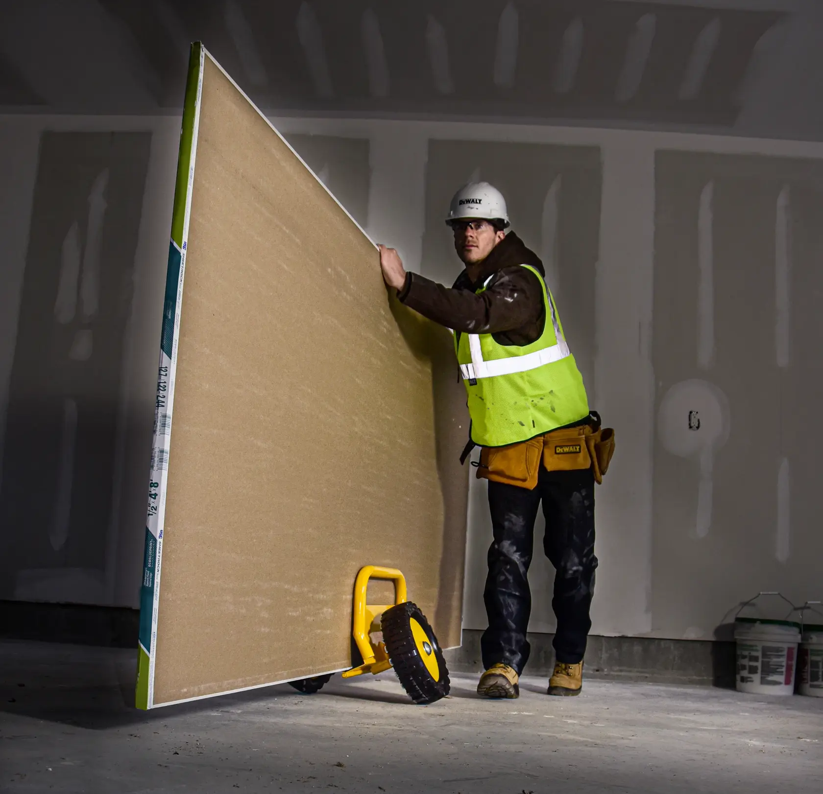 DeWalt DXWT-PS201 Door Dolly application shot - man pushing large board on dolly