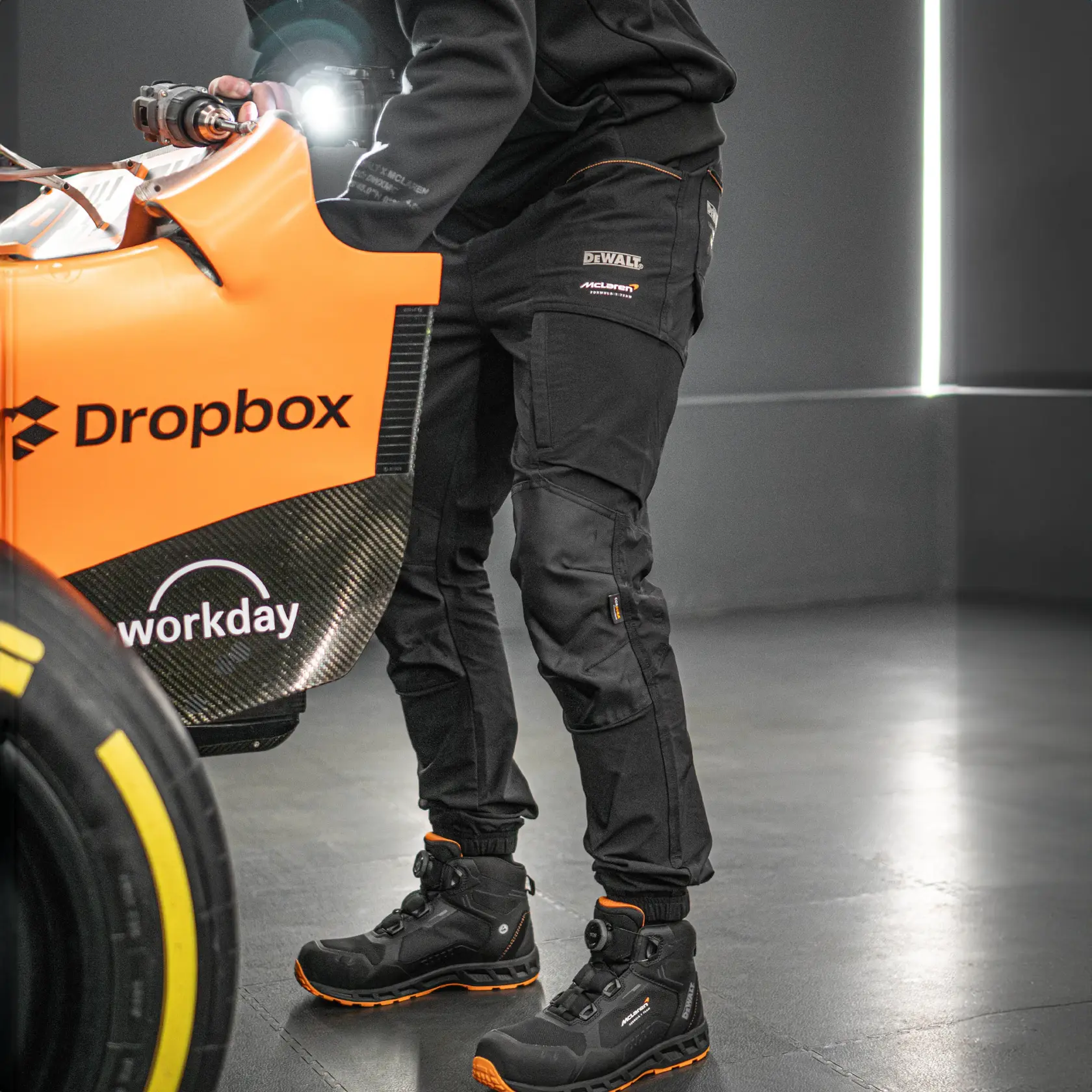 Front view facing left of the DEWALT x McLaren Webster men’s work jogger in black on model on location