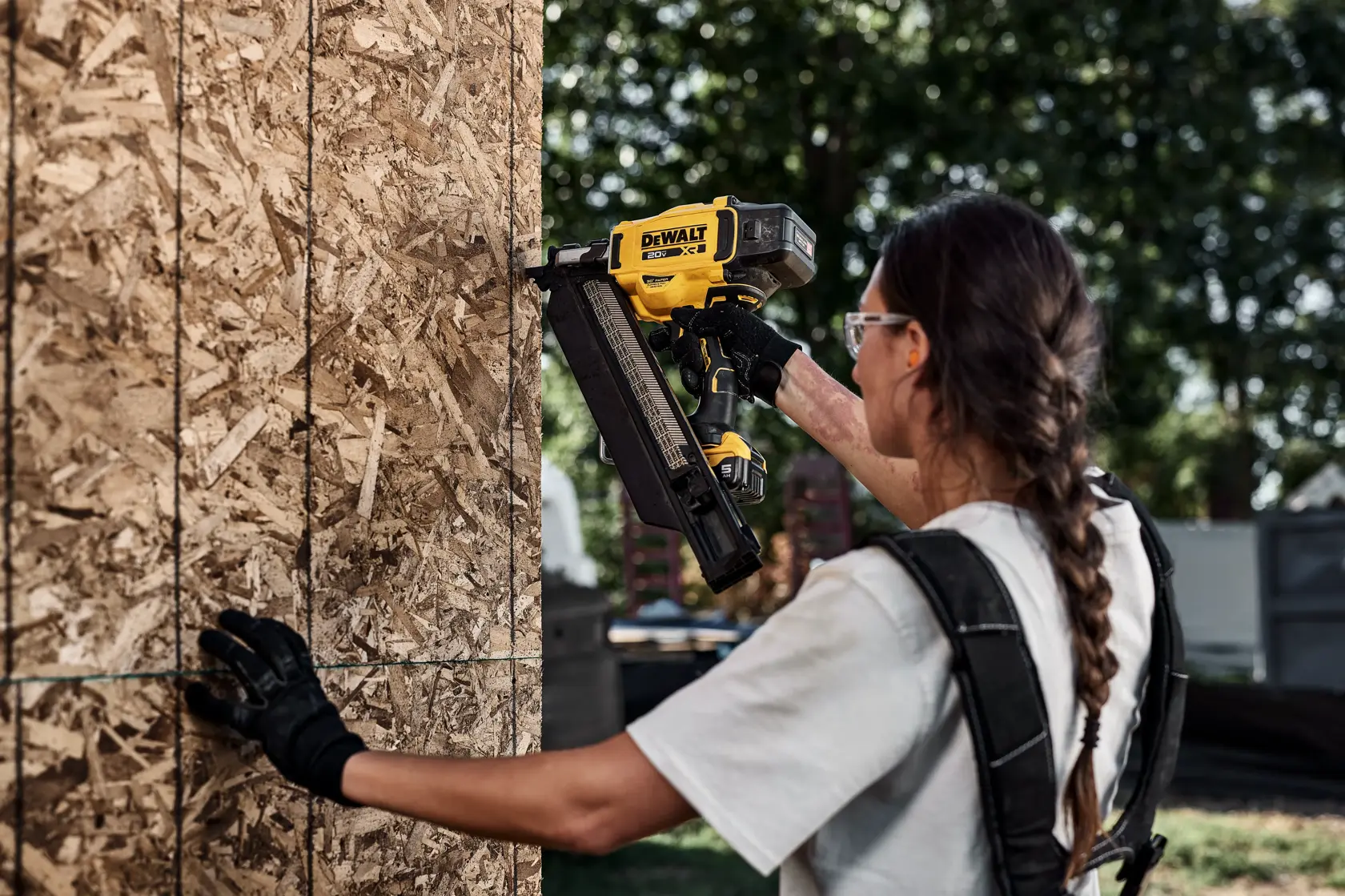 DEWALT 20V MAX* XR 30 Gauge Framing Nailer installing exterior wall sheathing with extended magazine
